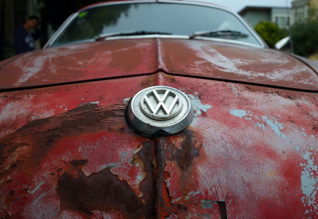 a red VW with rust