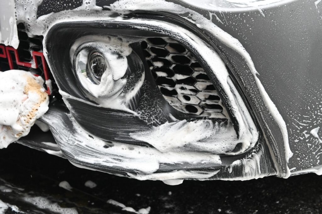 a car being cleaned with soap and water