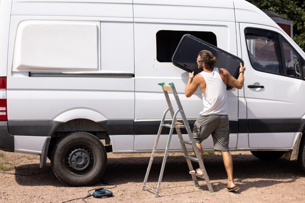 a man fitting a van window