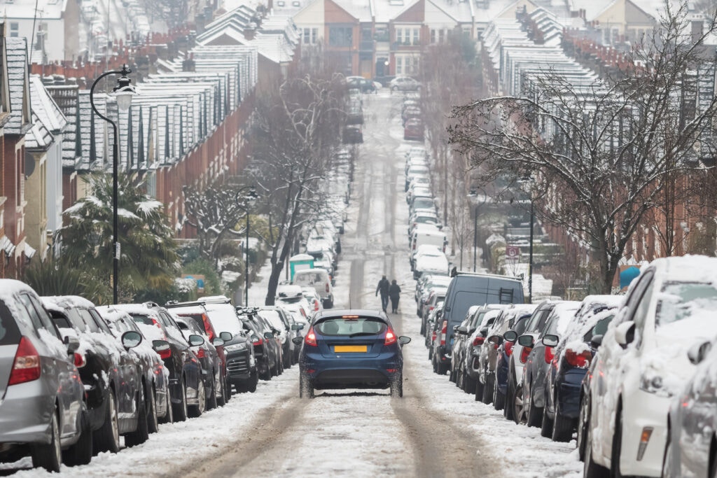 a car driving in snow down a hill