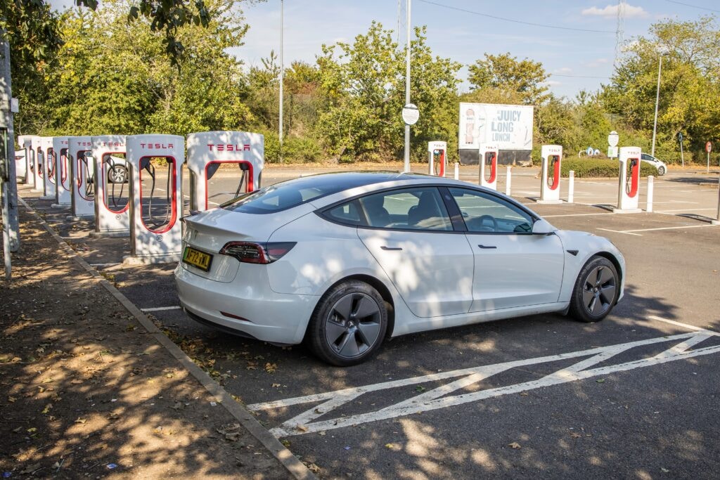 white tesla vehicle on charge 