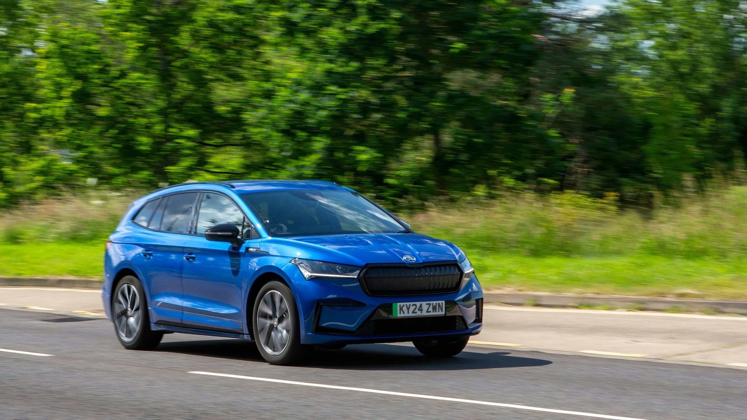 a blue EV driving 