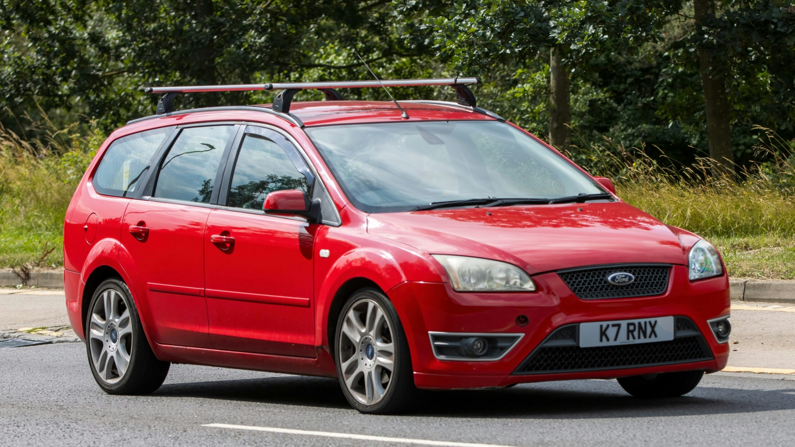 a red ford with a roof rack