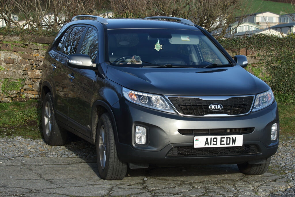 a kia sorento parked in a car park