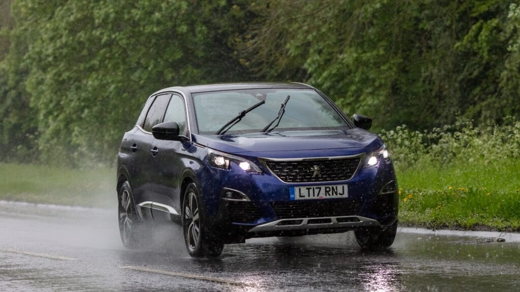 a Peugeot 3008 being driven in the rain