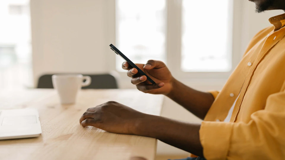 man at table on his phone