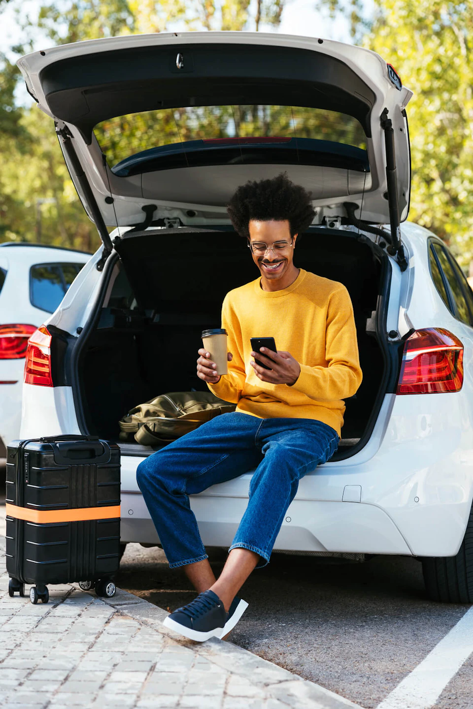 man sat in boot of car