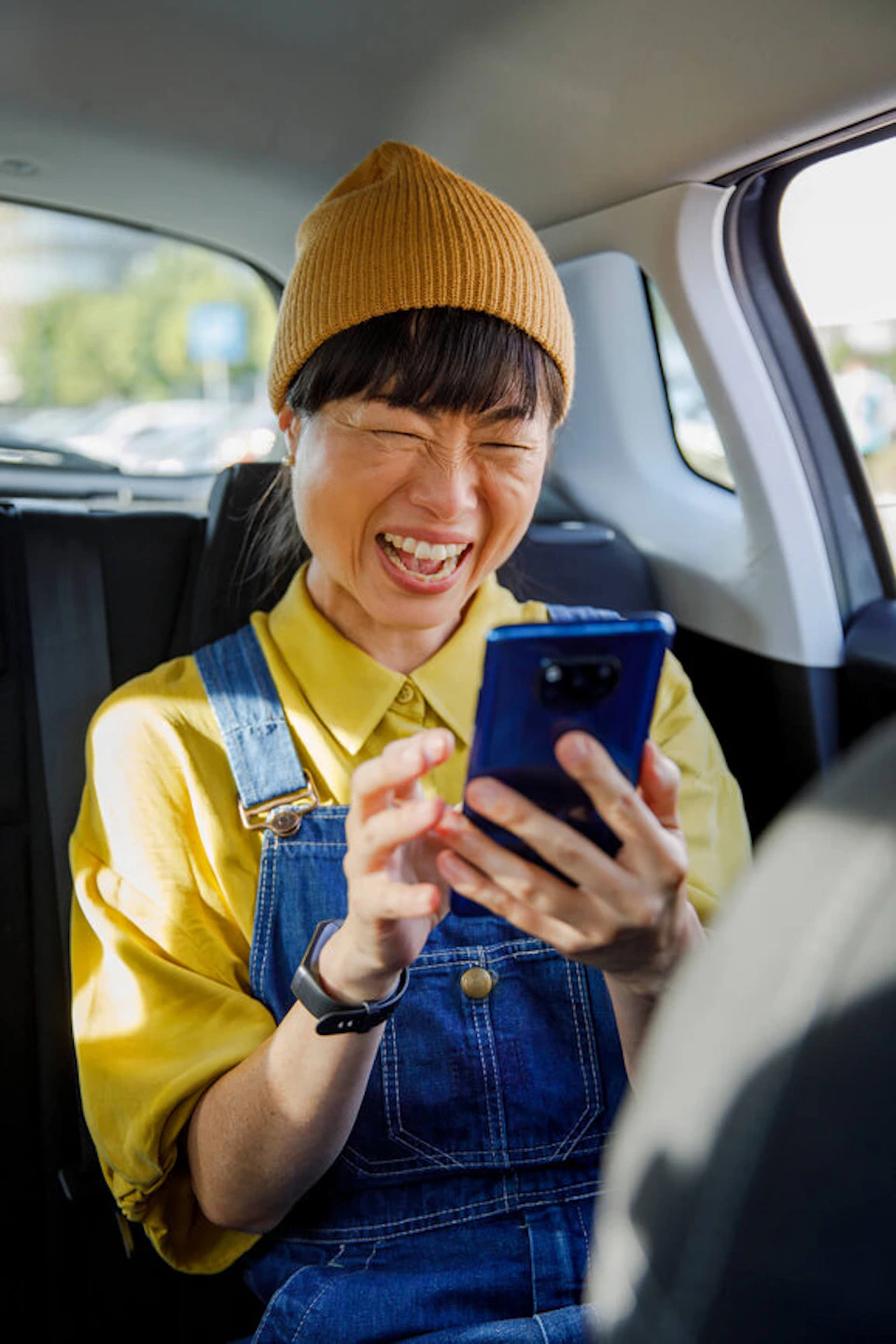 Woman laughing at her phone