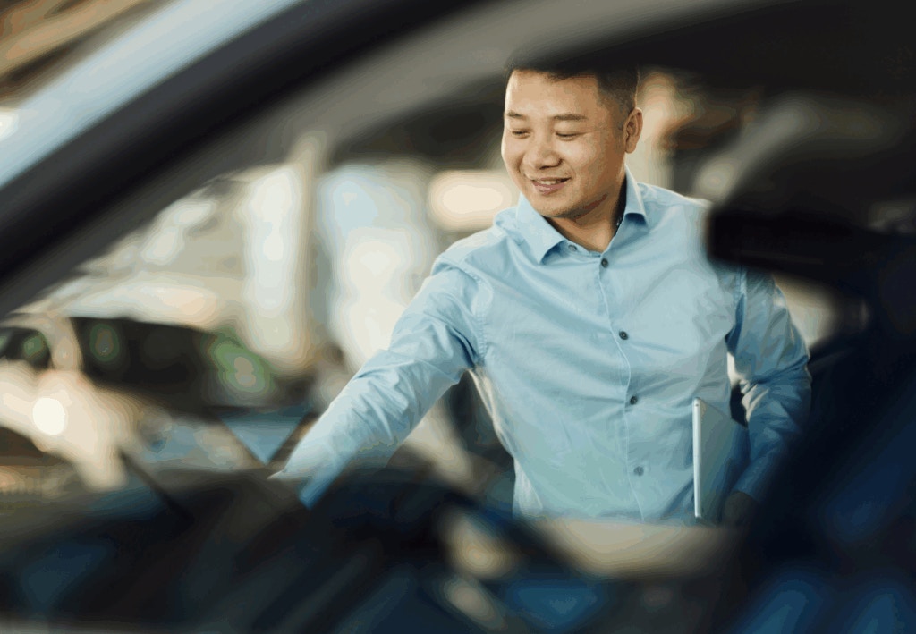 A dealer looking at a car
