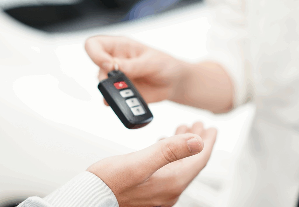 Someone handing over a car key
